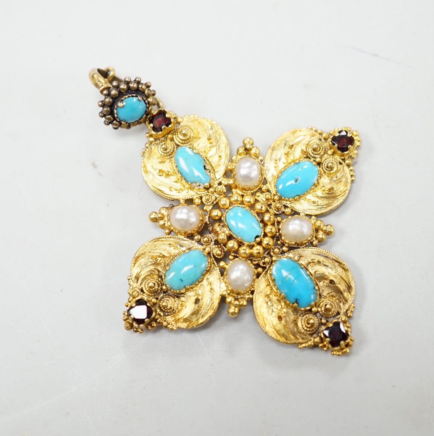 A 19th century yellow metal, turquoise, split pearl and garnet set quatrefoil pendant, overall 5cm, gross weight 7.5 grams.
